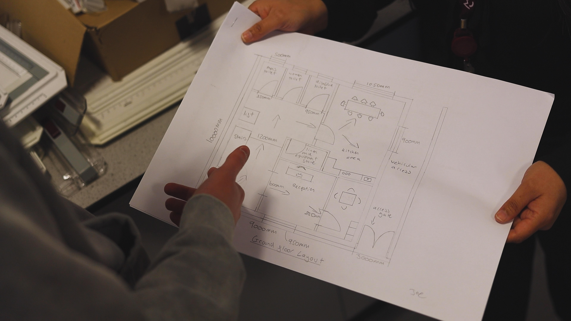 a student is looking at a building plan