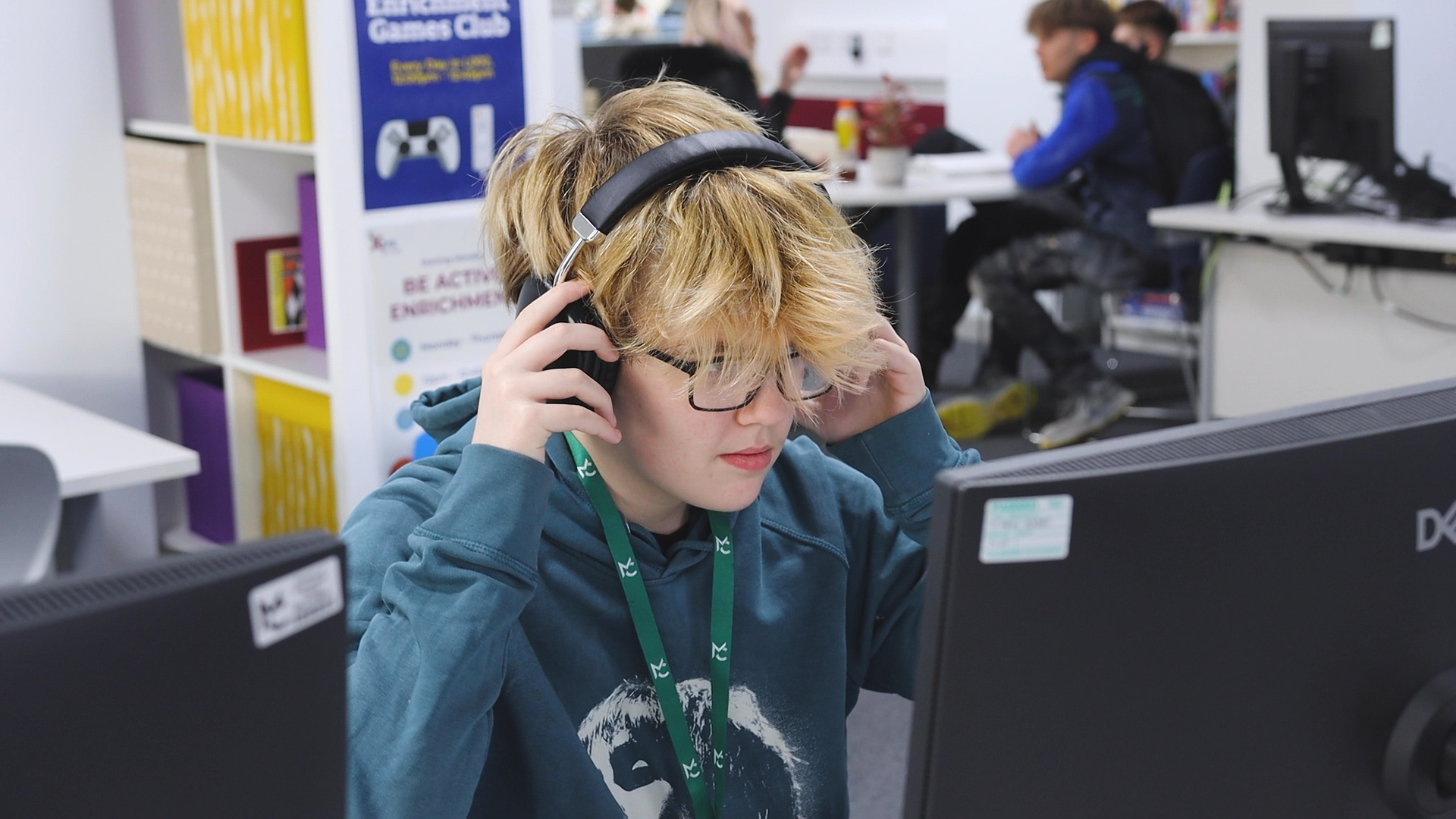 a student is wearing headphones whilst working on a computer