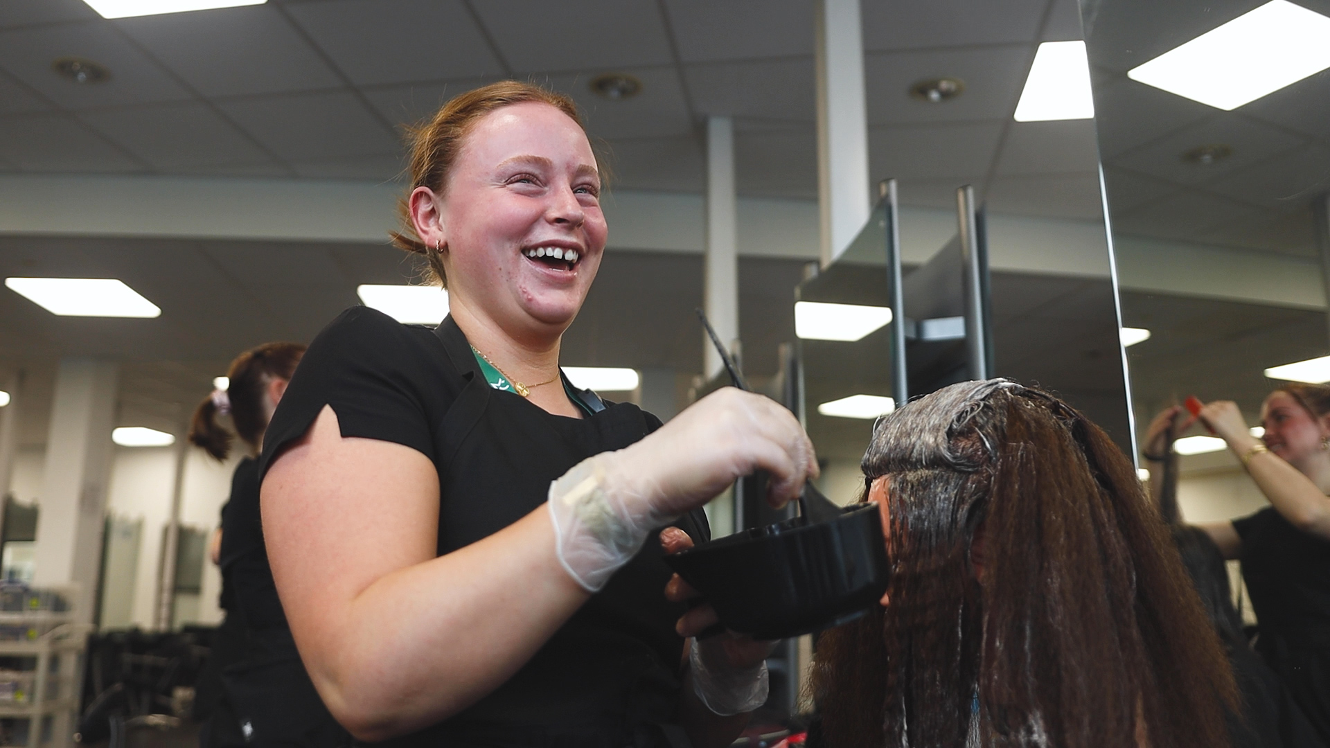 a hairdressing student smiling