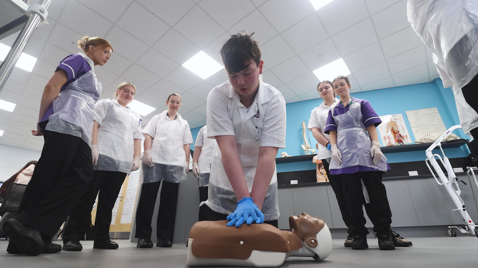A health student demonstrates CPR techniques to other students