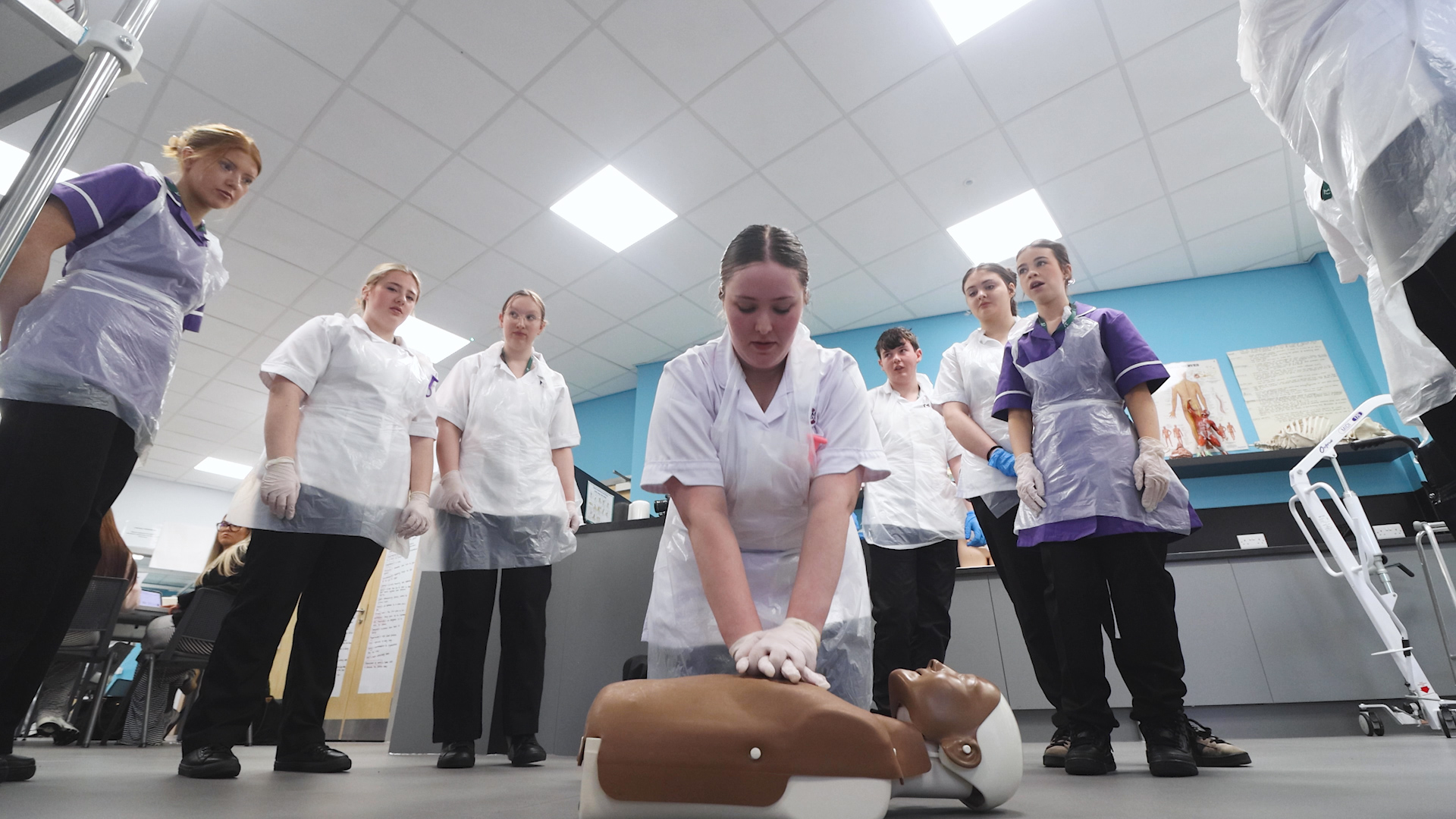 A health student demonstrates CPR techniques to other students