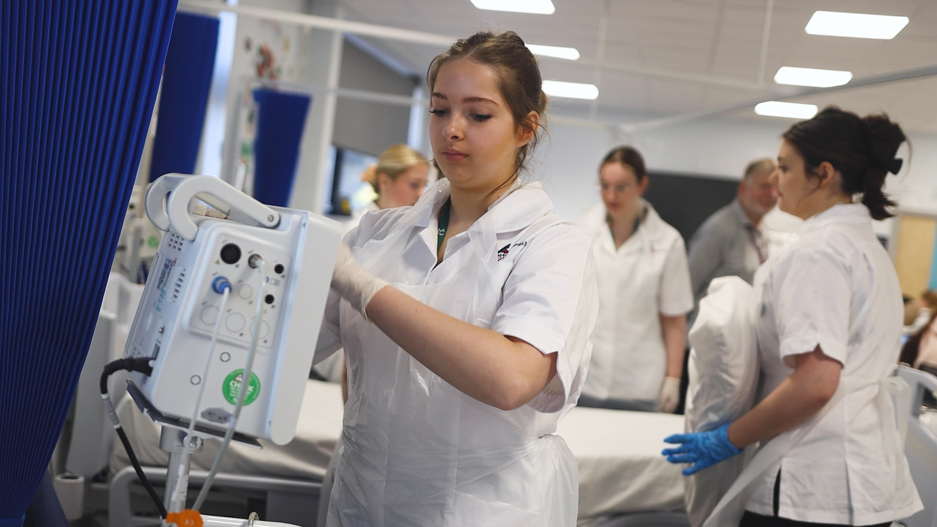 a health student sets up a blood pressure machine