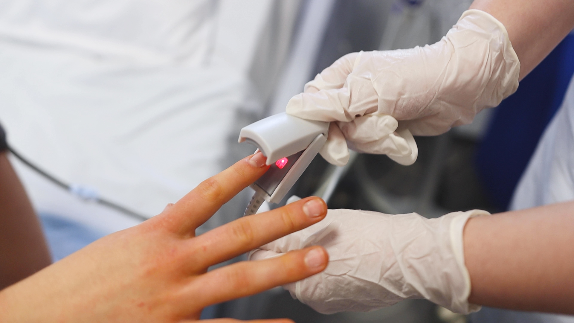 A health student attaches a monitoring machine to a another student