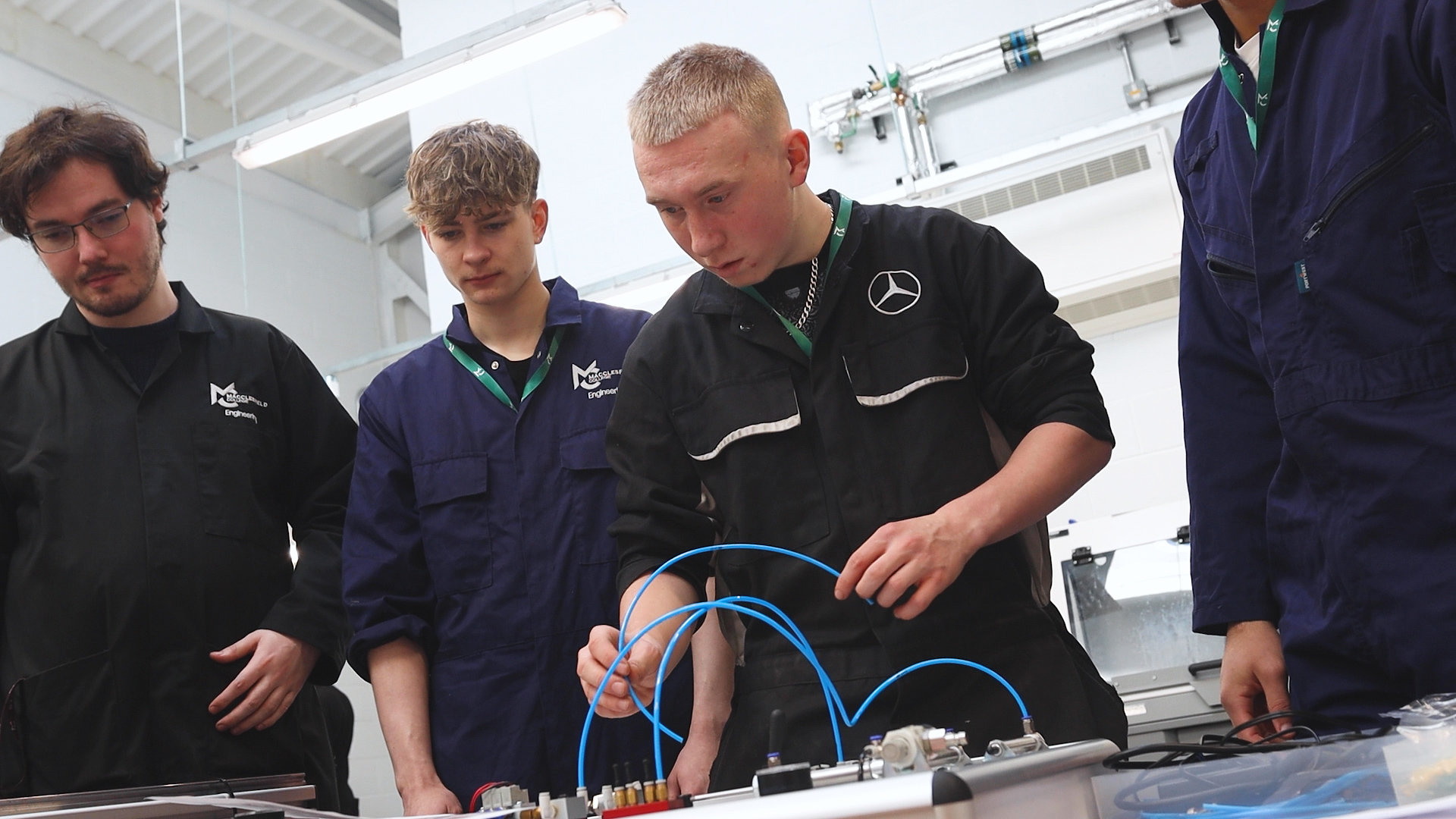Engineering students using a hydraulics trainer machine