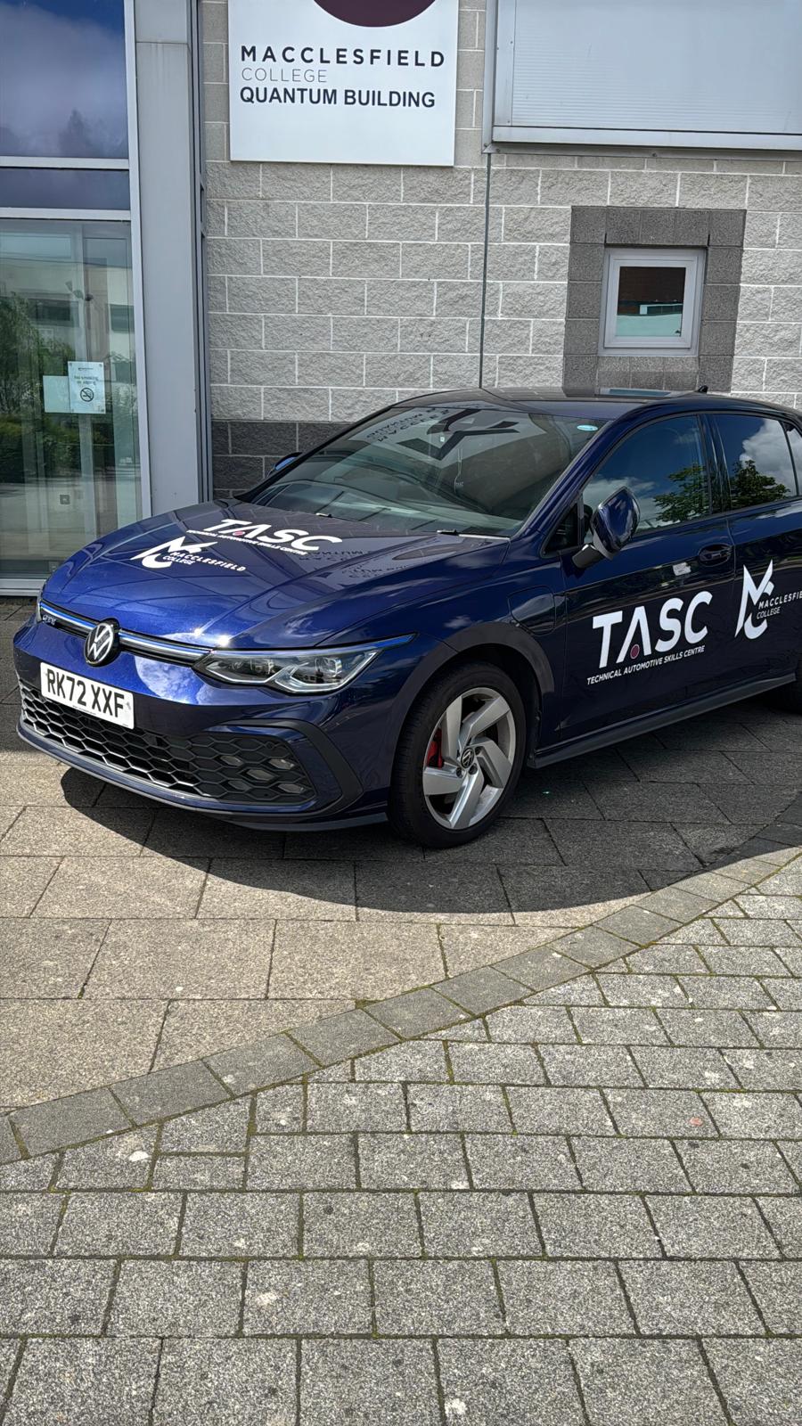 a blue car that has tasc macclesfield college branded on it