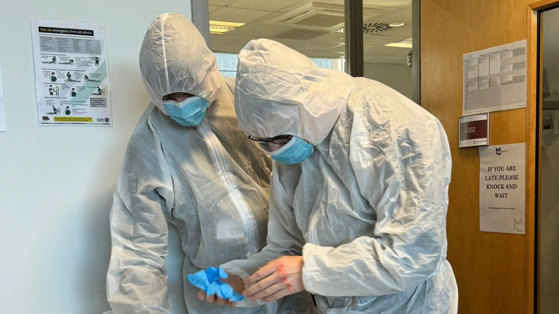 Two public service students dressed in integration scrubs are analysing evidence