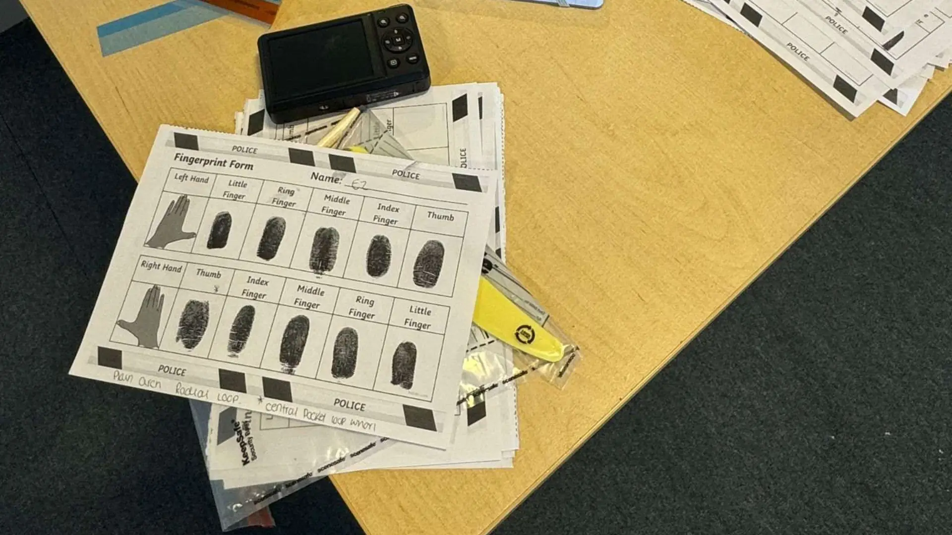 Fingerprint papers are placed on a table