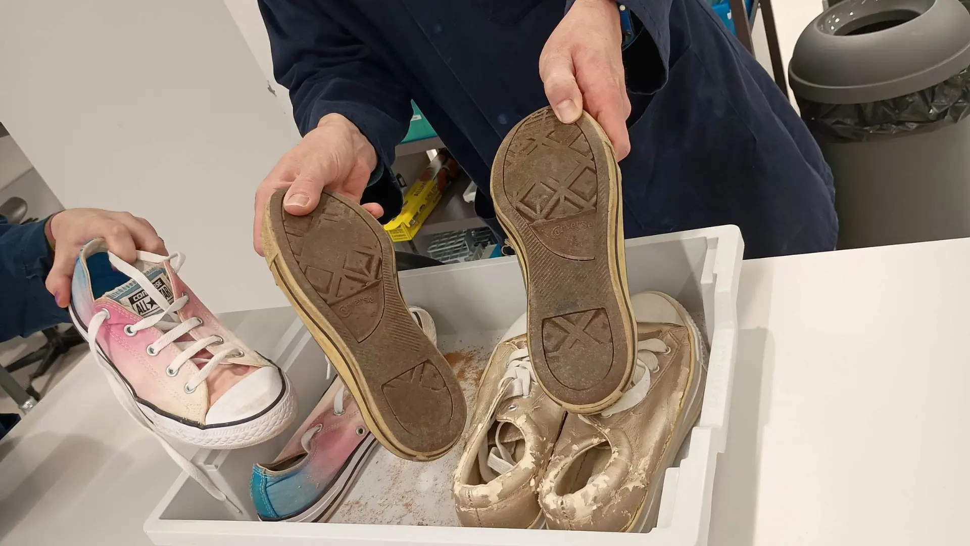 A student is holding a footprint casting of footprints