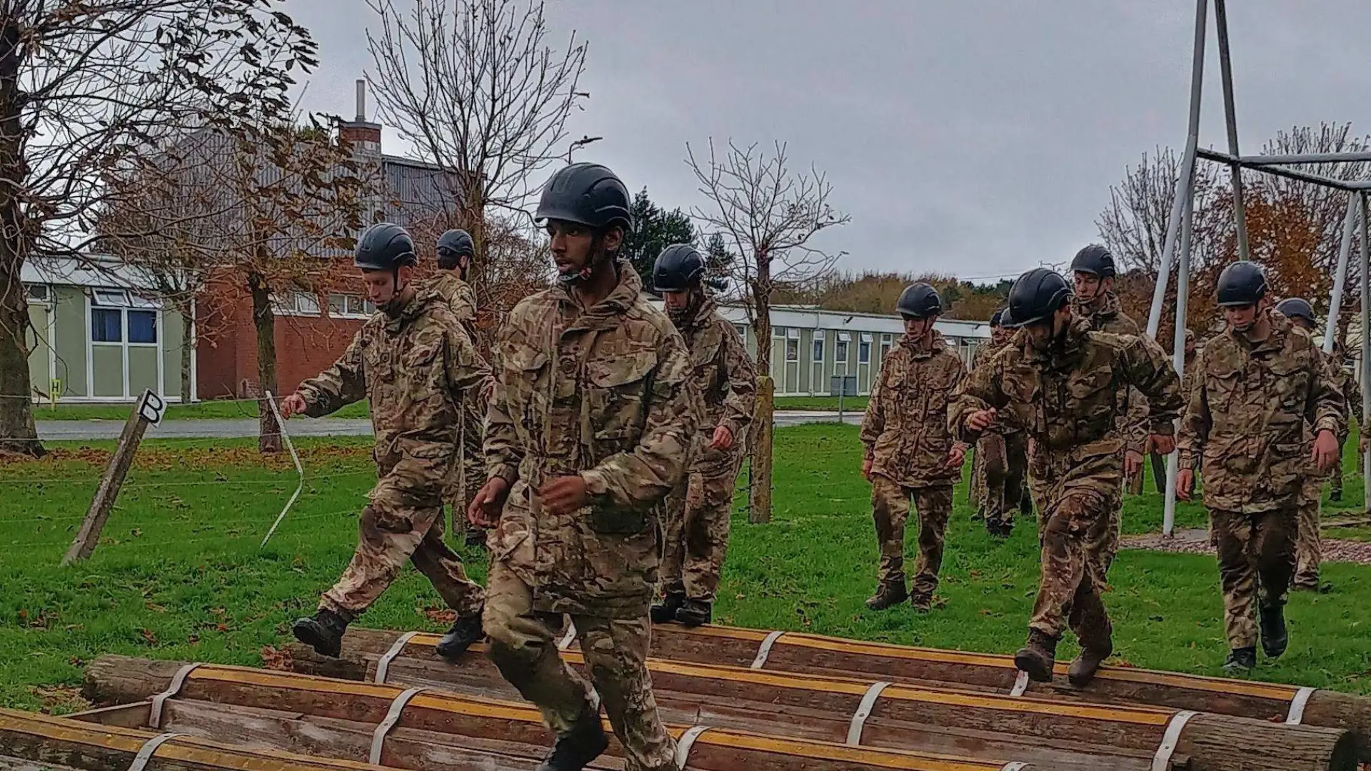 A group of students dressed in army clothes are running