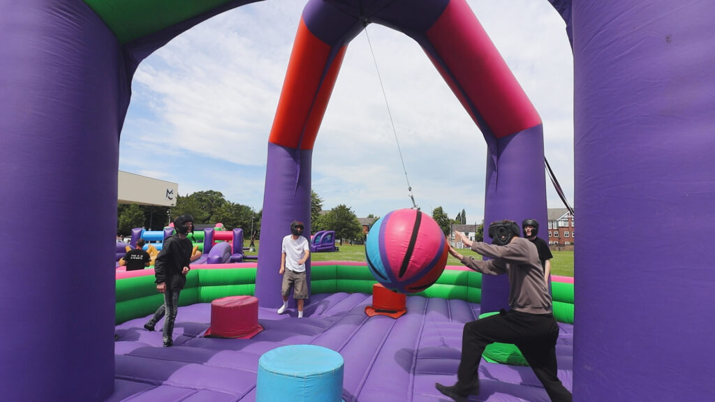 a group of students are playing on a bouncy