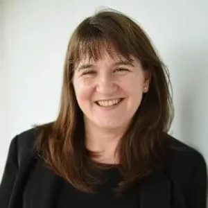 A headshot photo of one of the College's Governors smiling
