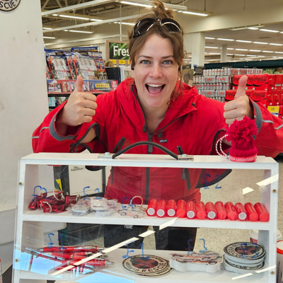 A member of Glossop Mountain Rescue standing with one of the display cases made by students from Macclesfield College
