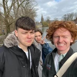 A group of students are smiling for a photo during a work experience trip