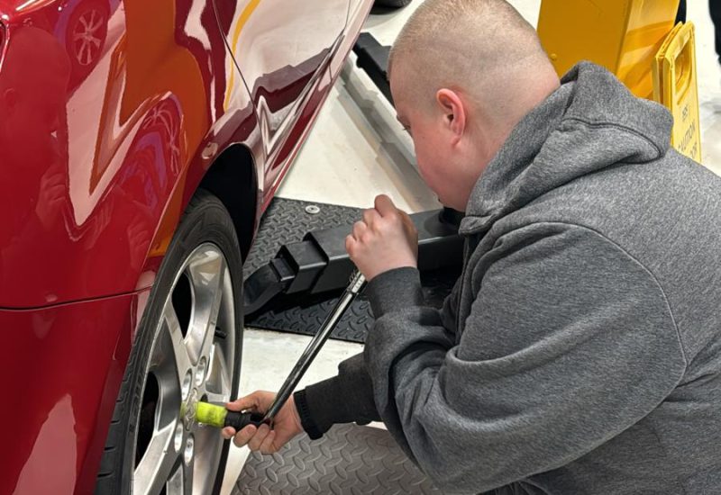 An Automotive adult learner checking a tyre